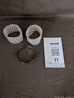 Pair of faux pearl cuffs and silver-tone bracelet overview