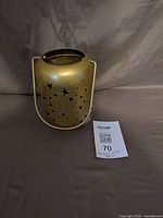 Front view of brushed gold star cutout candle holder with handle