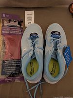 Top view of sneakers and packaged insoles