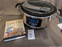 Hamilton Beach programmable slow cooker with probe next to recipe book