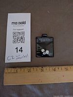 Overview of Lindenwold's card with three stones and scale