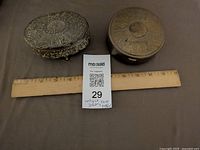 Both jewelry boxes with ruler for scale