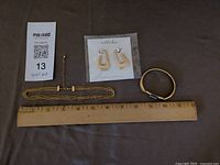 Overview of all jewellery pieces with ruler for scale