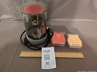 Warmer, two packaged wax bars, loose cubes, ruler for scale