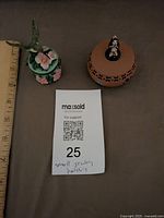 Both trinket boxes next to ruler for scale