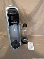 Front view of SodaStream unit with bottle