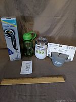 All four items grouped: frother box, water bottle, tumbler, snack cup