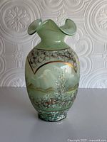 Full view of vase showing ruffled rim and painted landscape