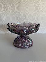 Overall view showing pedestal candle holder profile and iridescent finish