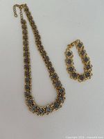 Necklace and bracelet laid flat showing full design and link pattern