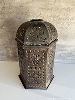 Front view showing full hexagonal lantern with pierced designs and patina