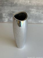 Full view of polished silver-tone Nambe Studio vase