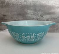 Side view showing turquoise exterior and Amish Butterprint pattern