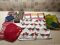 Group shot of all textiles: tea towels, oven mitt, pot holder, napkins, tote