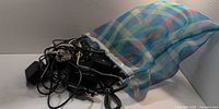 Bag spilling assorted chargers and cables