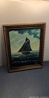 Full view of framed sailboat painting