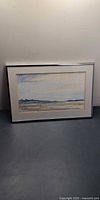Front view of framed watercolor painting showing coastal landscape scene