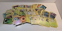 Pile of yellow-border Pokémon cards spread out
