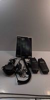 Two Nokia 6160 phones with chargers, earpiece and manuals on tabletop