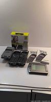 All devices laid out: Motorola Cantel MicroTAC, Motorola hands-free kit box, two Nokia 232 phones, Palm PDA, Nokia manuals