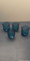 Group shot of all four blue pressed glass tumblers