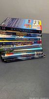 Stack of eight DVD movies, spine titles visible