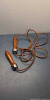 Full view of leather jump rope with wooden handles