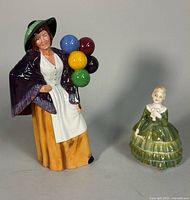 Balloon Lady and Belle figurines side by side