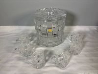 Covered crystal punch bowl with six mugs displayed