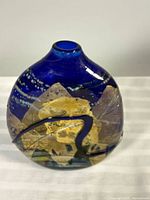 Front view of cobalt blue Jamie Sherman blown glass vase with gold foil panels and ribbon swirl