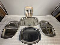 Five stainless trays and wood-stand fondue forks overview