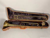 Trombone in open hard case with lyre