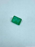 Rectangular green gemstone on white background