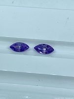 Pair of purple marquise-cut cubic zirconia stones on tray