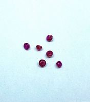 All six rubies grouped on light background showing size and color