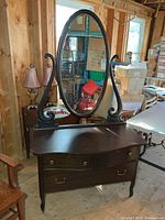 Full view of dresser with attached oval mirror