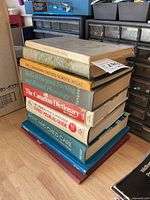Stack of eight books showing spines and covers