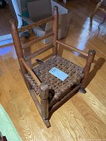 Front angle view of childs wooden rocking chair showing overall design