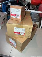 Three stacked Lightolier boxes showing model numbers 513WHX and 379WHX