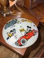 Top view of Disney glass shade showing characters and central mounting hole