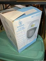 Front angled view of opened retail box showing product image and branding