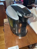 Front and side view of Keurig brewer showing reservoir and overall condition