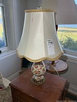 Lamp on side table showing full height with cream shade