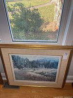 Framed print standing below window