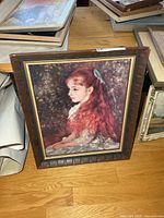 Full view of framed Renoir art print on floor