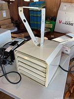 Front view of louvered 240V shop heater with bracket attached