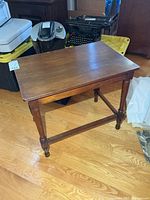 Full view of wood side table with legs and stretcher