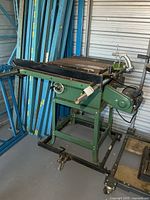 Overall view of green Mao Shan table saw on stand