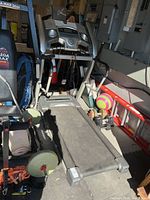 Full view of treadmill folded down in garage