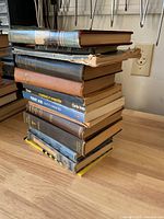 Full stack of vintage books on tabletop